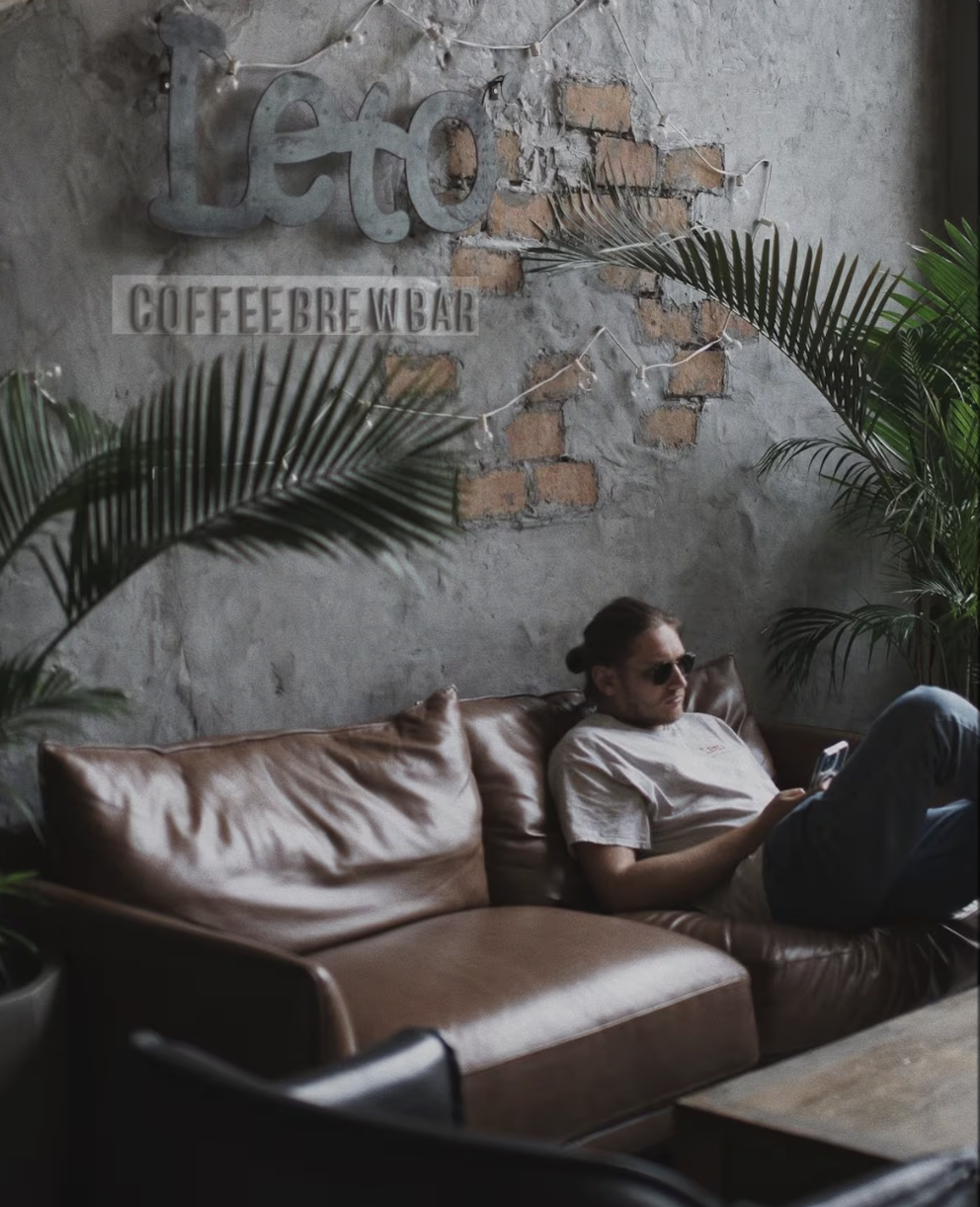 Two people in conversation across a quiet table in a Panama City office.