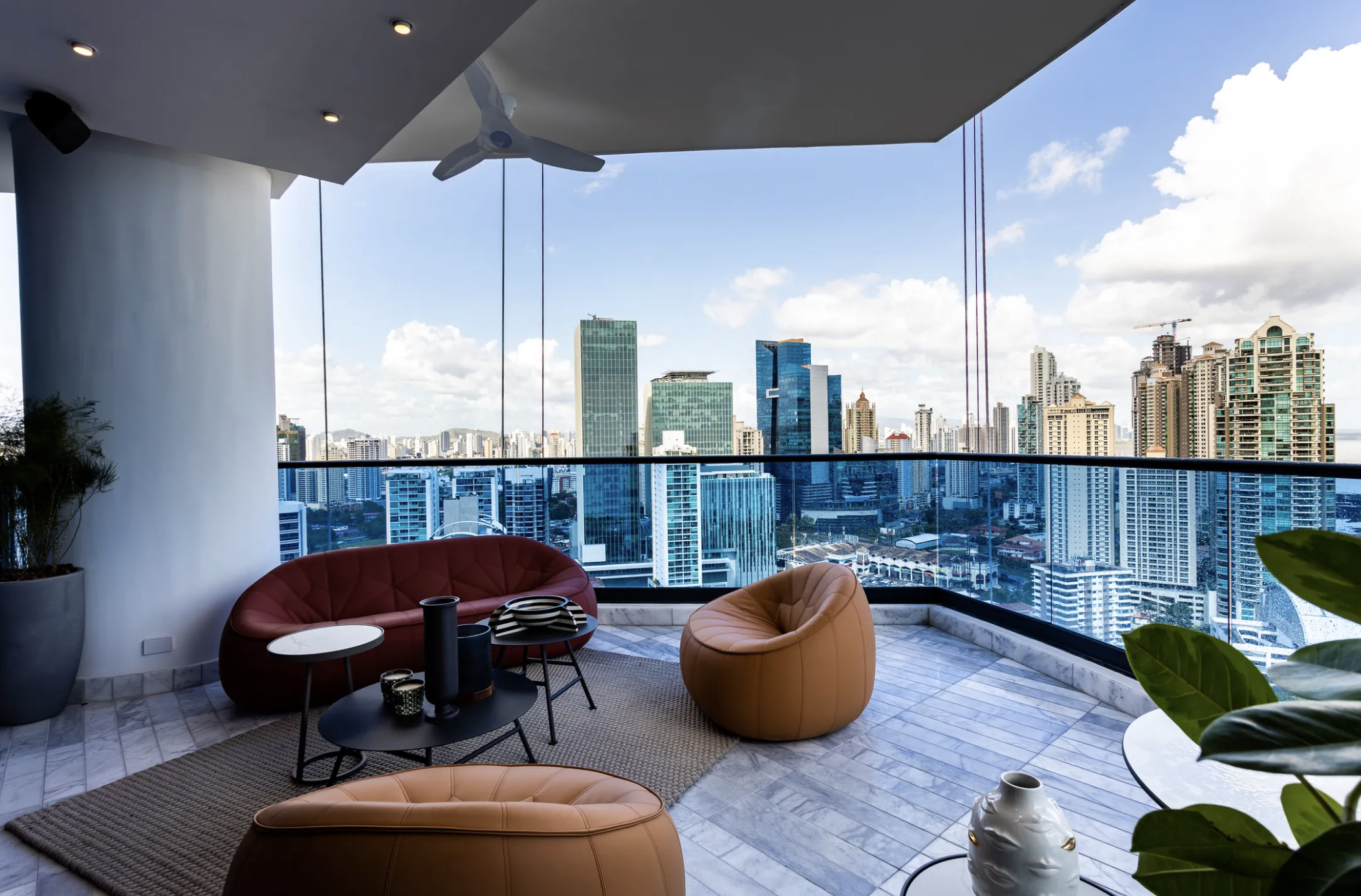 Living room of a modern Panama City apartment with wide windows.