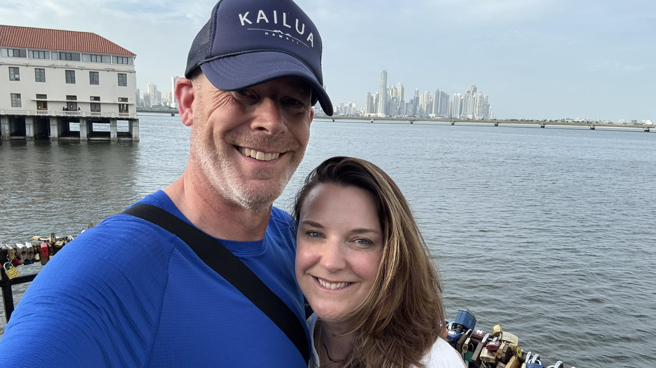 A couple in their mid-sixties walking through a Panama City residential area.